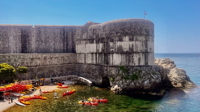 Dubrovnik's stone fortifications rise above the blue Adriatic Sea