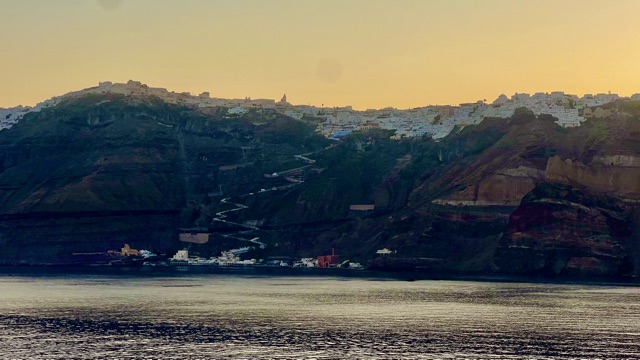 Whitewashed Santorini buildings overlook the blue Aegean caldera