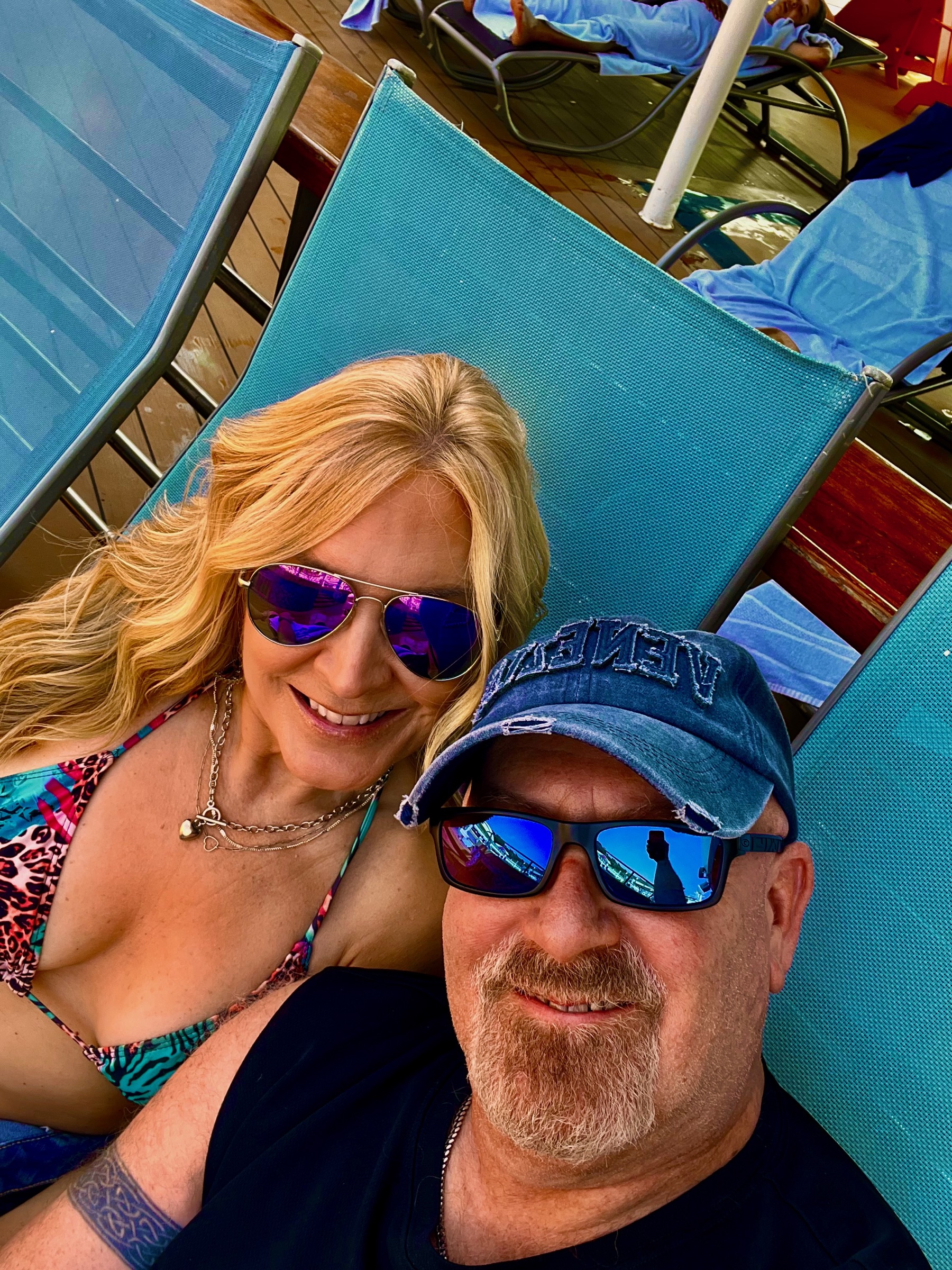 Steve and Dianne relaxing together on the sunny pool deck