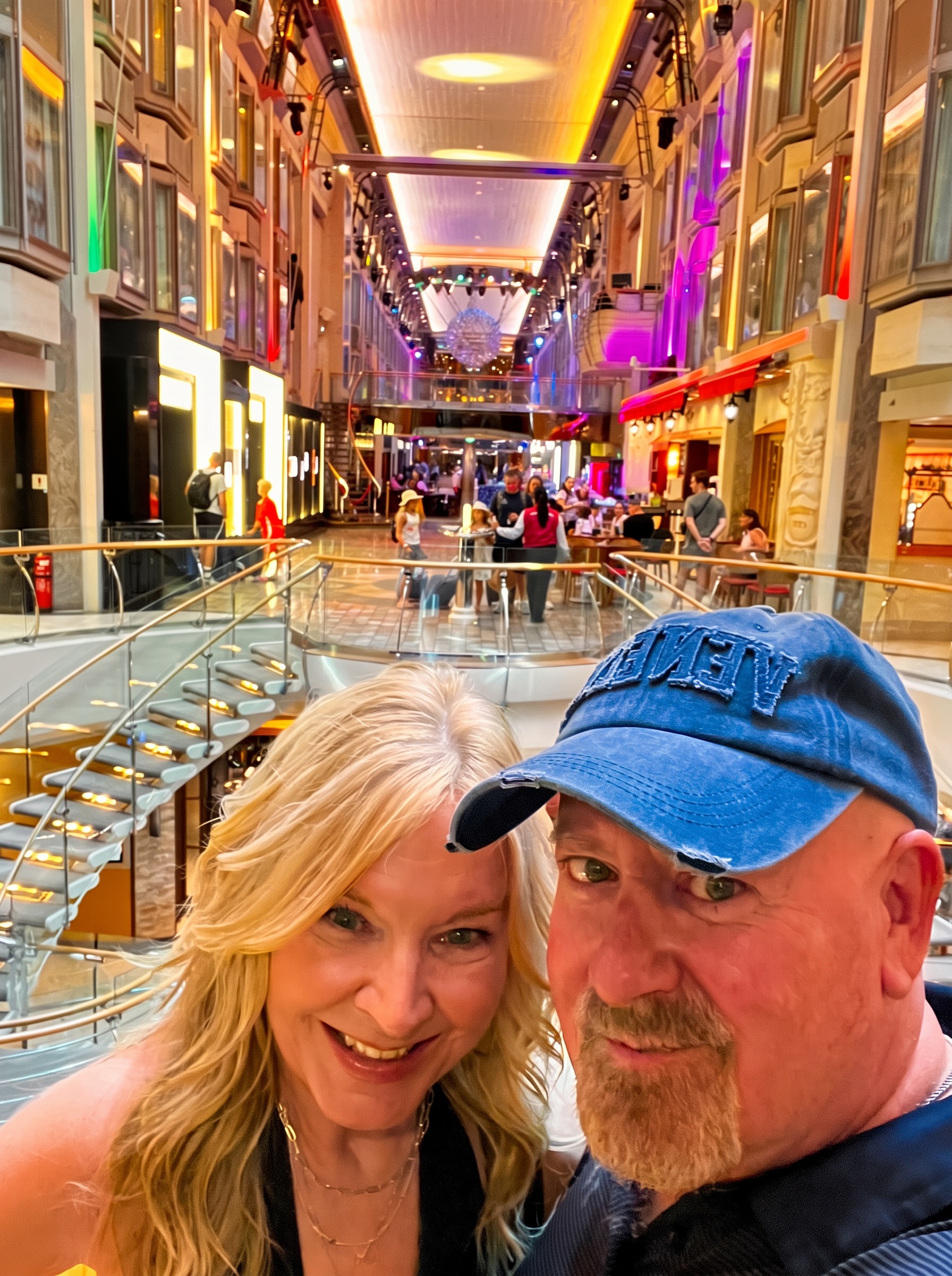 Steve and Dianne together inside the colorful Royal Promenade aboard Explorer of the Seas