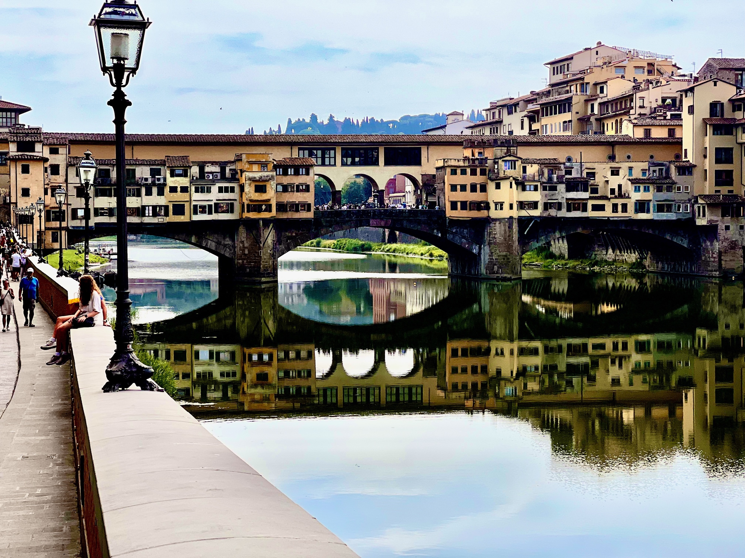 Ponte Vecchio and its riverside buildings reflected in the Arno in Florence