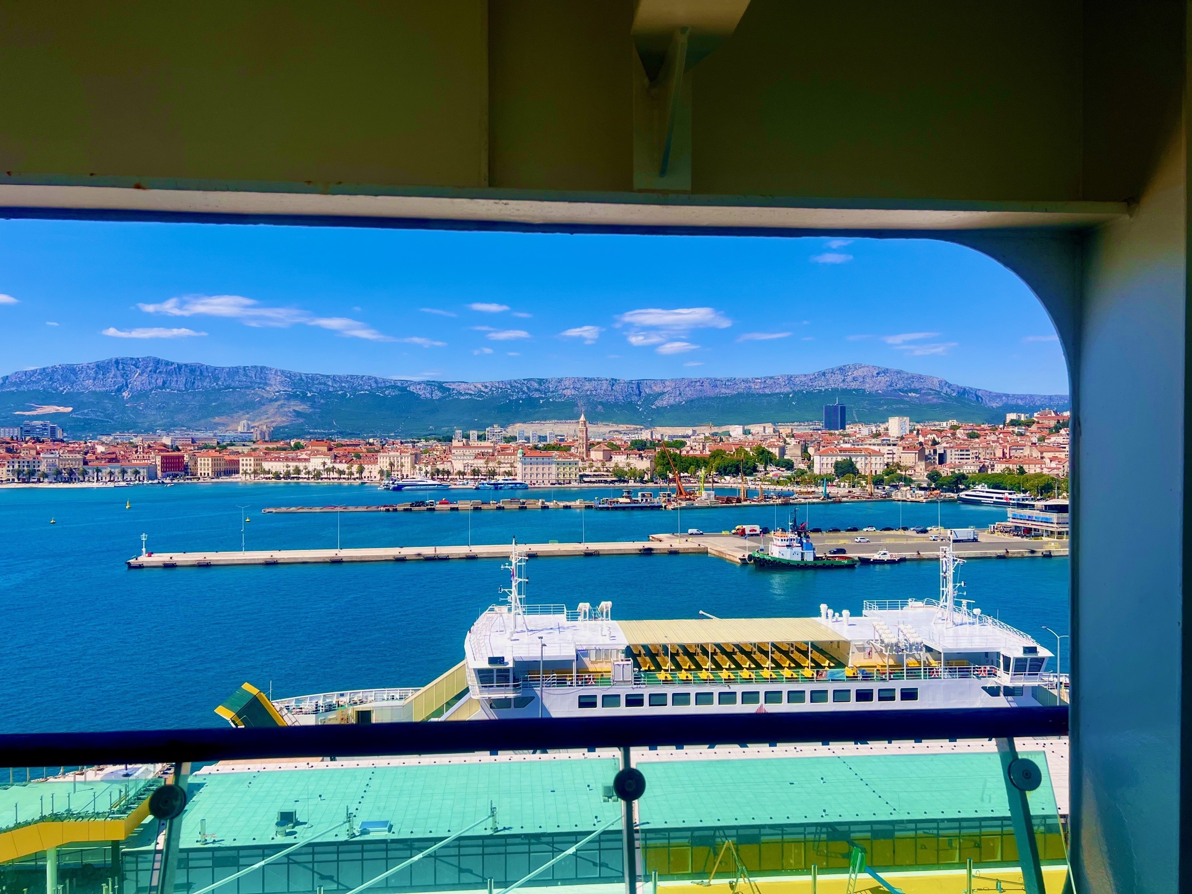 Split's waterfront and mountain backdrop viewed across the harbor from a cruise ship