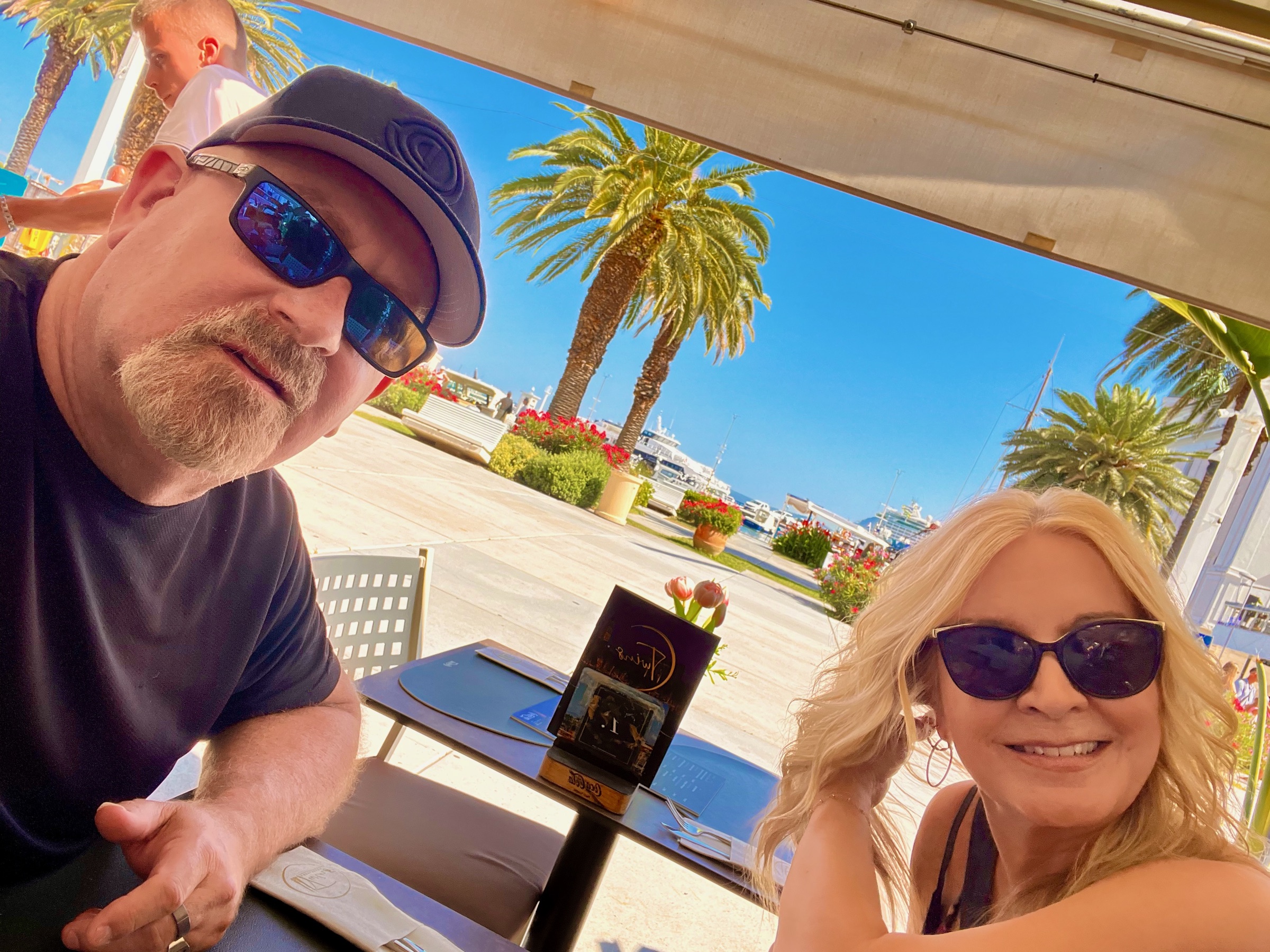 Steve and Dianne together at a waterfront café beside Split's palm-lined Riva