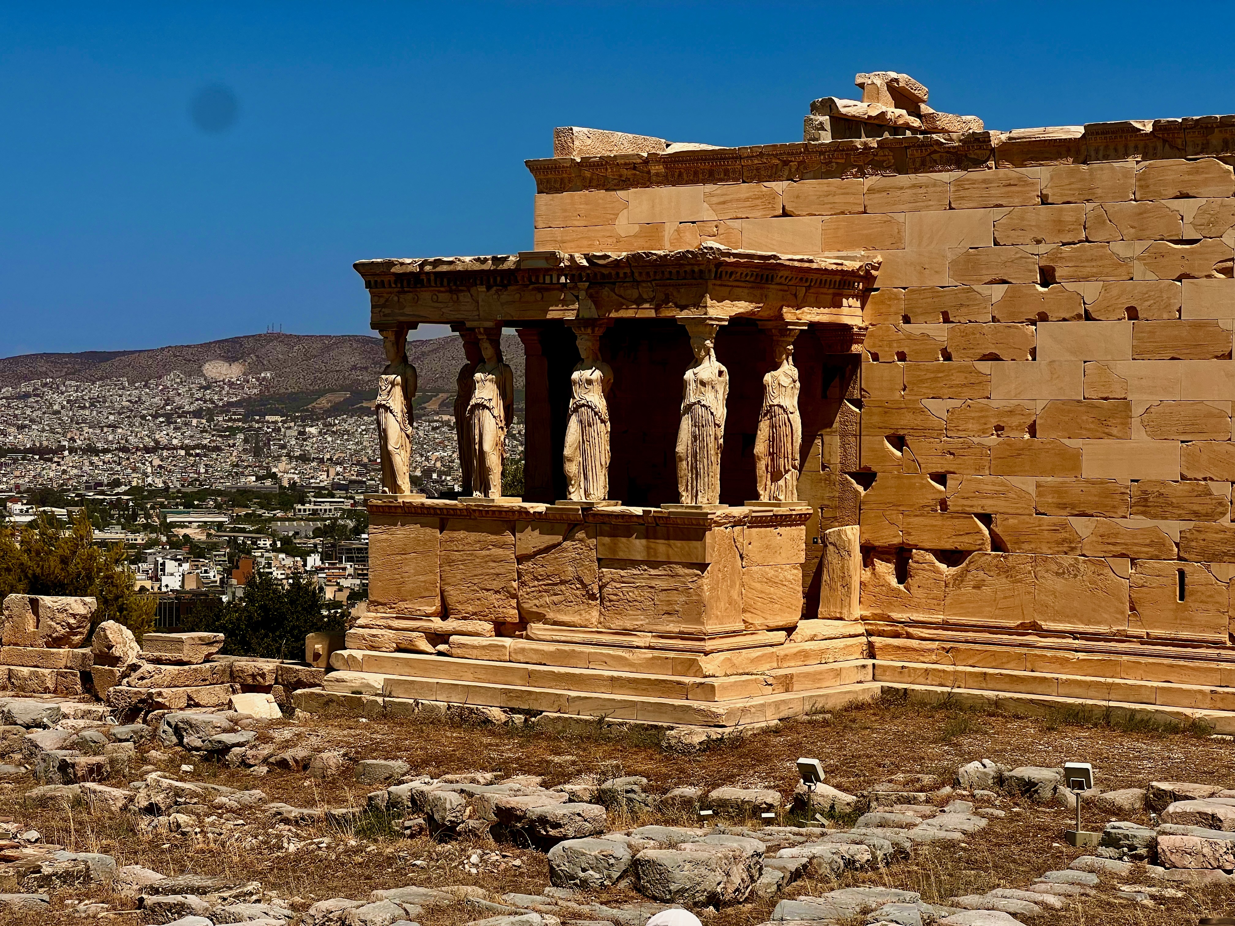 Ancient structures and visitors on the Acropolis in Athens