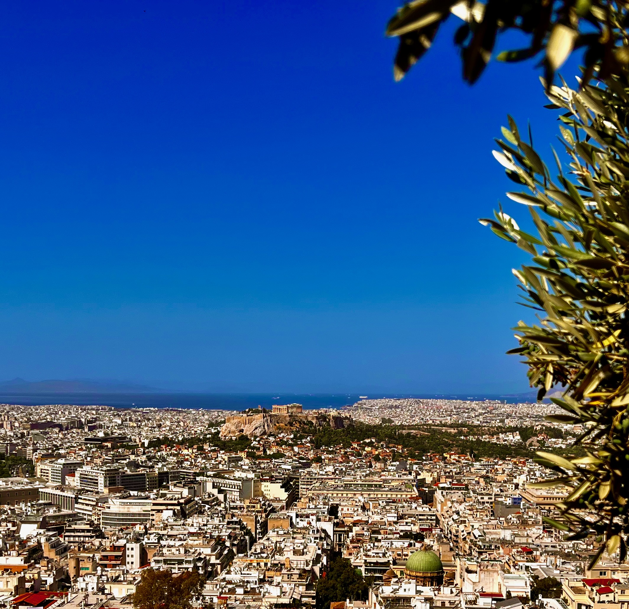 A panoramic view of Athens with the Acropolis rising above the city
