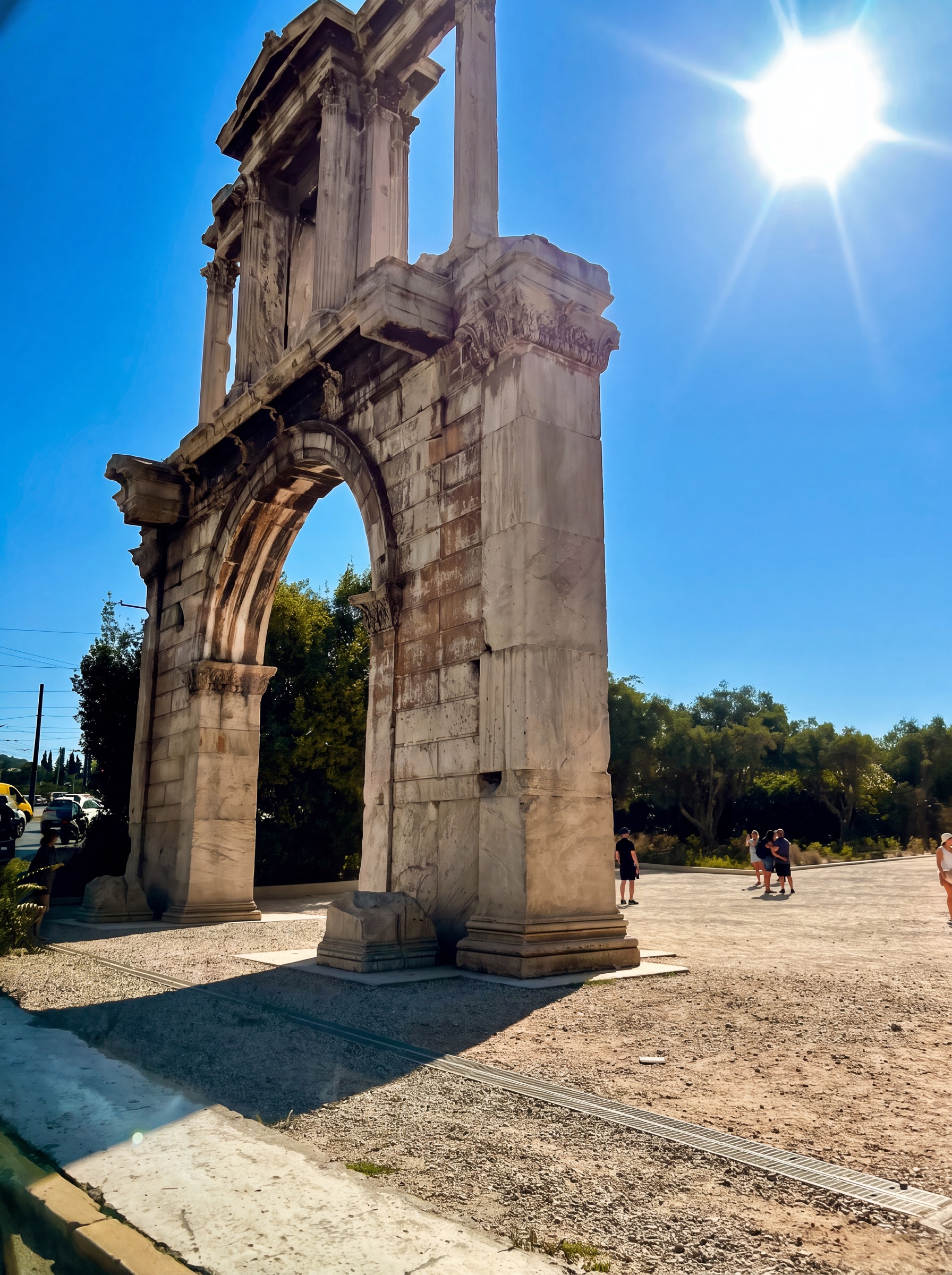 Hadrian's Arch illuminated by the morning sun beneath a clear blue sky