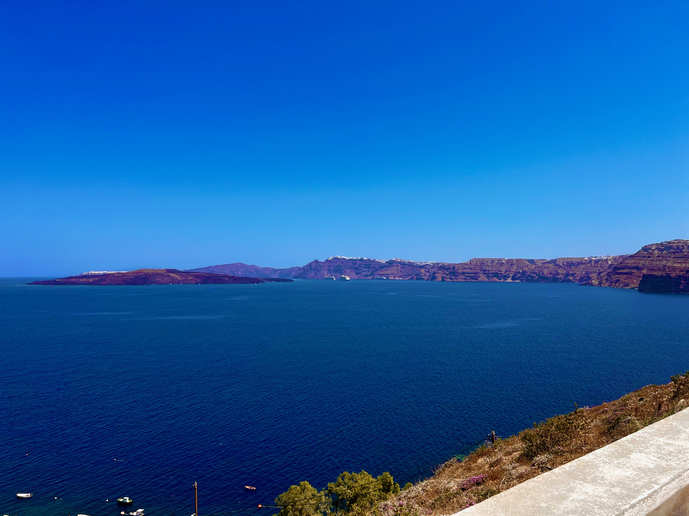 Santorini's broad flooded caldera surrounded by layered volcanic cliffs