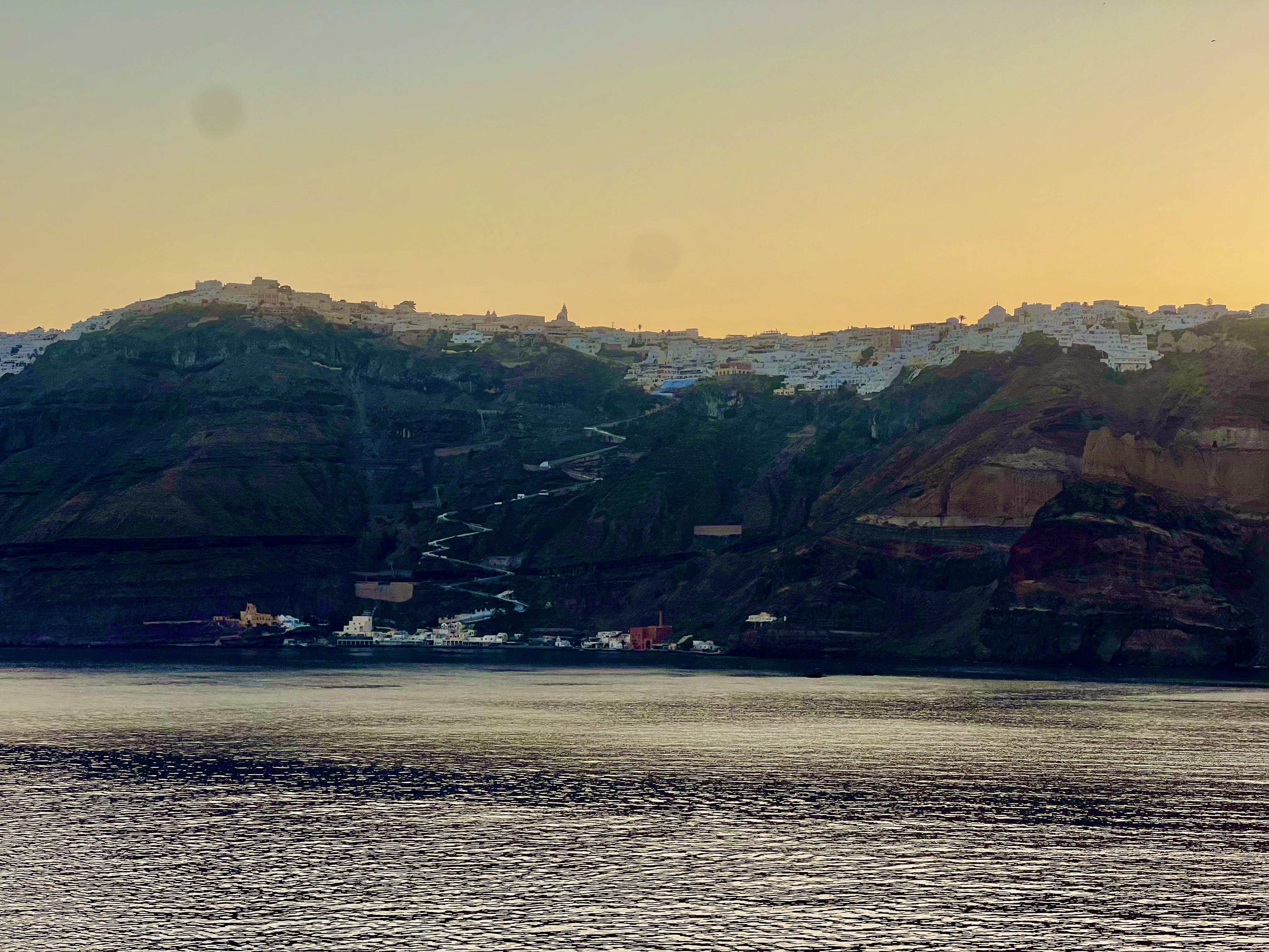 Santorini's volcanic cliffs and white villages viewed across the caldera