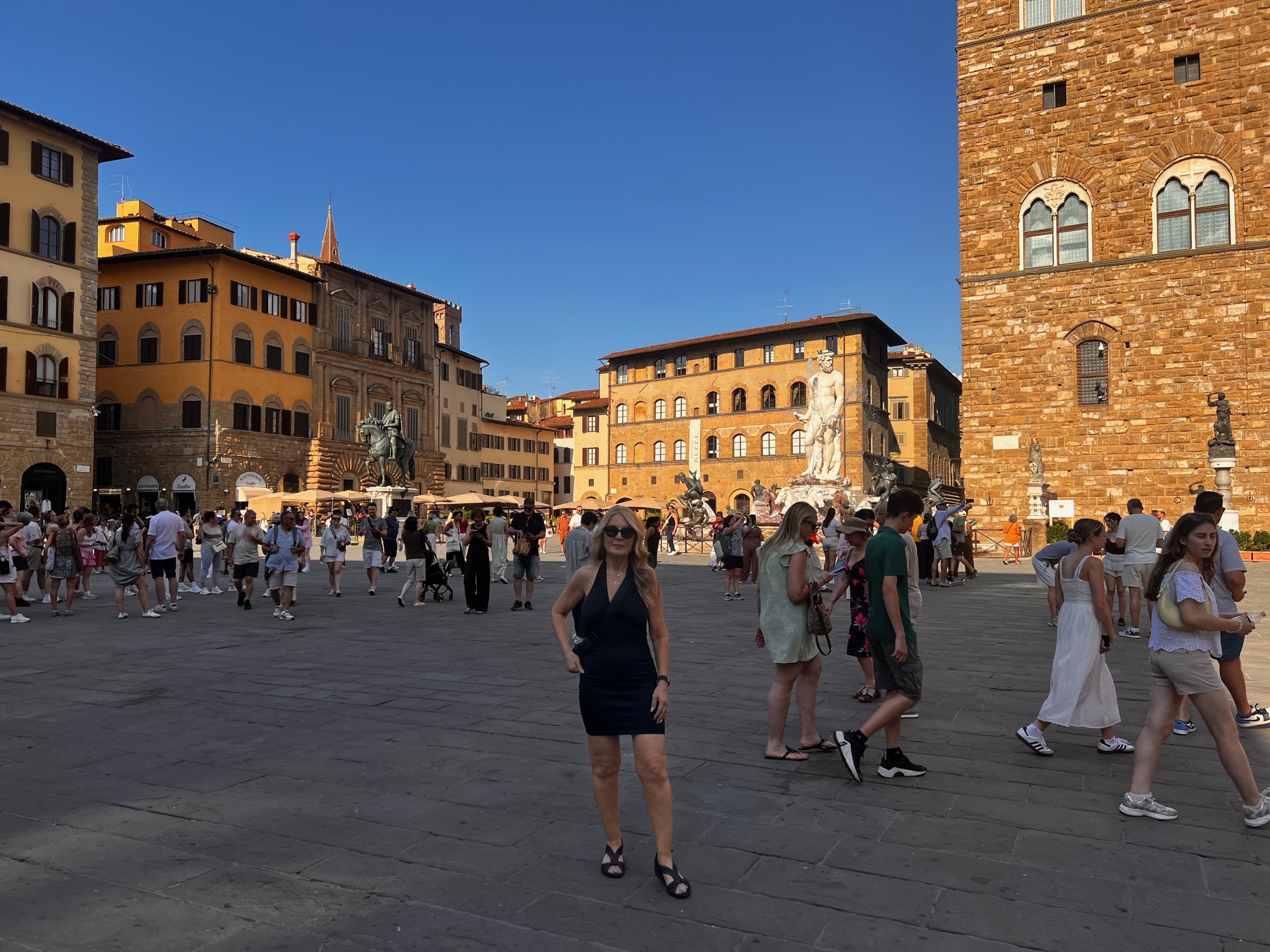Dianne standing in the sunlit Piazza della Signoria