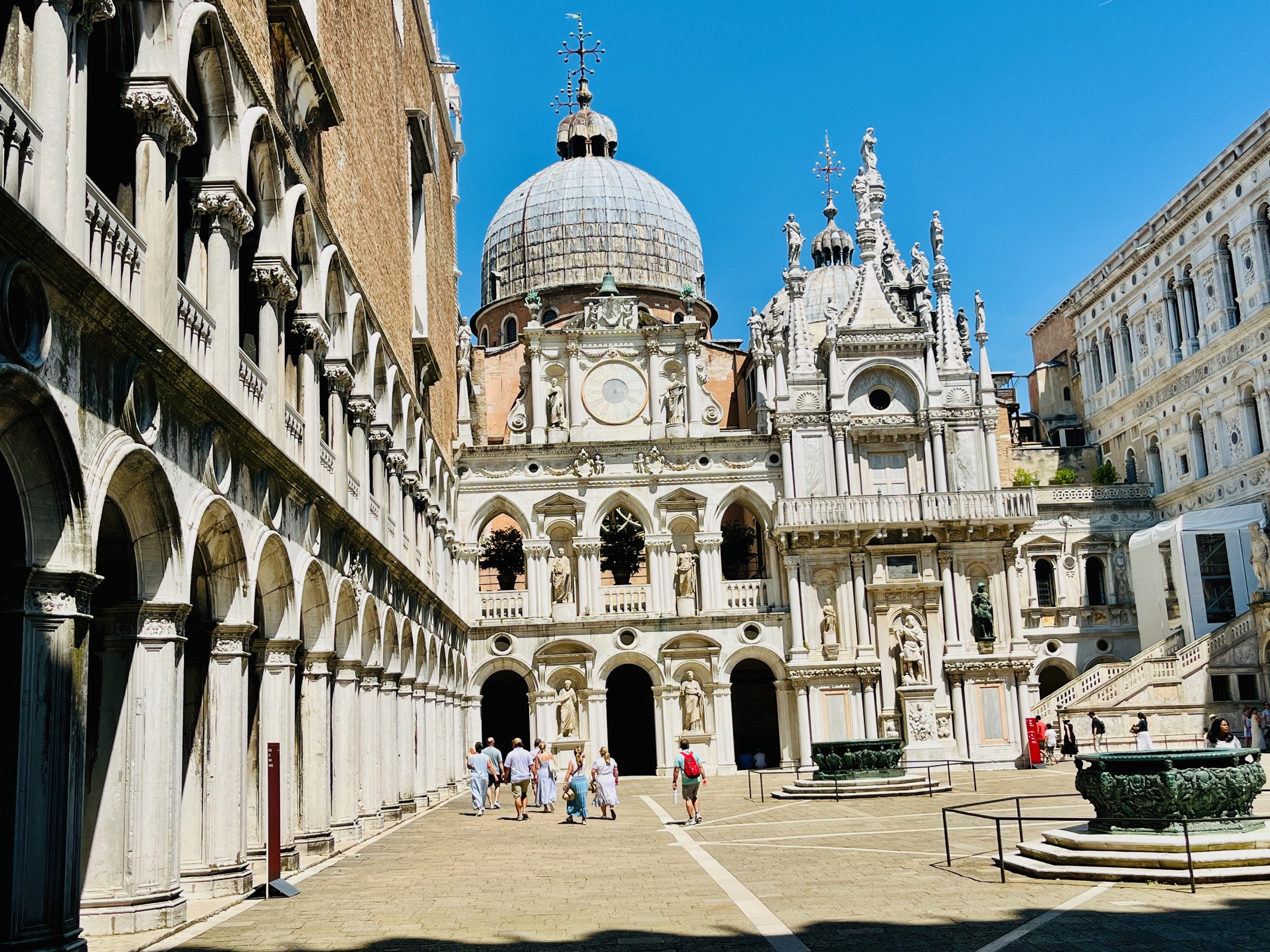 Sunlit courtyard framed by historic Venetian architecture