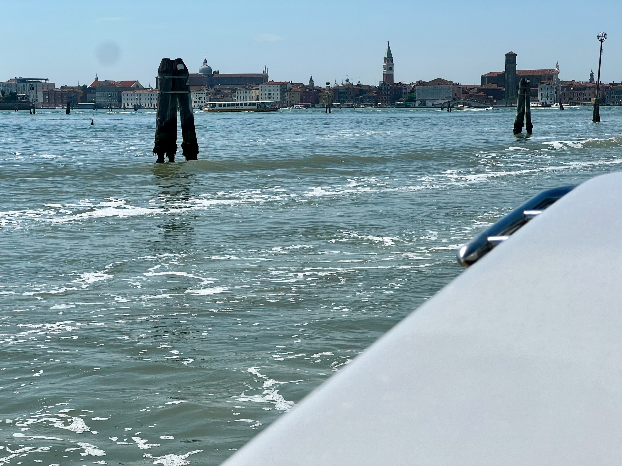 Venice skyline viewed across the lagoon beneath a blue sky